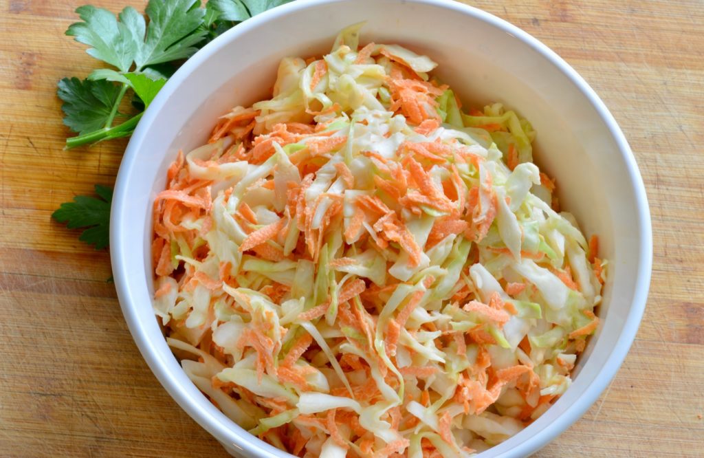 Coleslaw in a bowl with parsley garnish