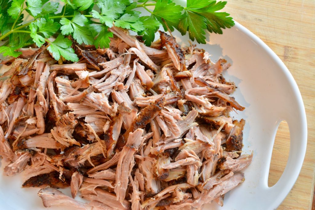 shredded oven roasted pulled pork on a platter