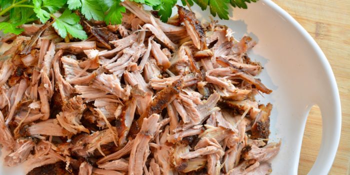 shredded oven roasted pulled pork on a platter